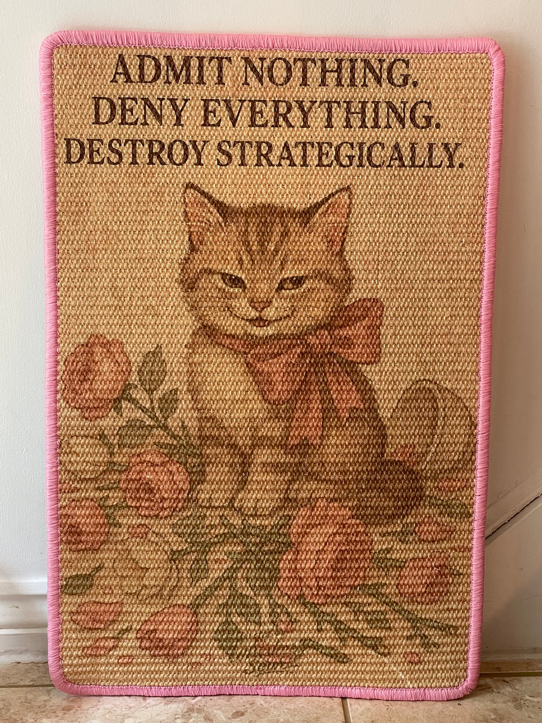 Cat scratching mat with crime scene design and guilty-looking cartoon cat