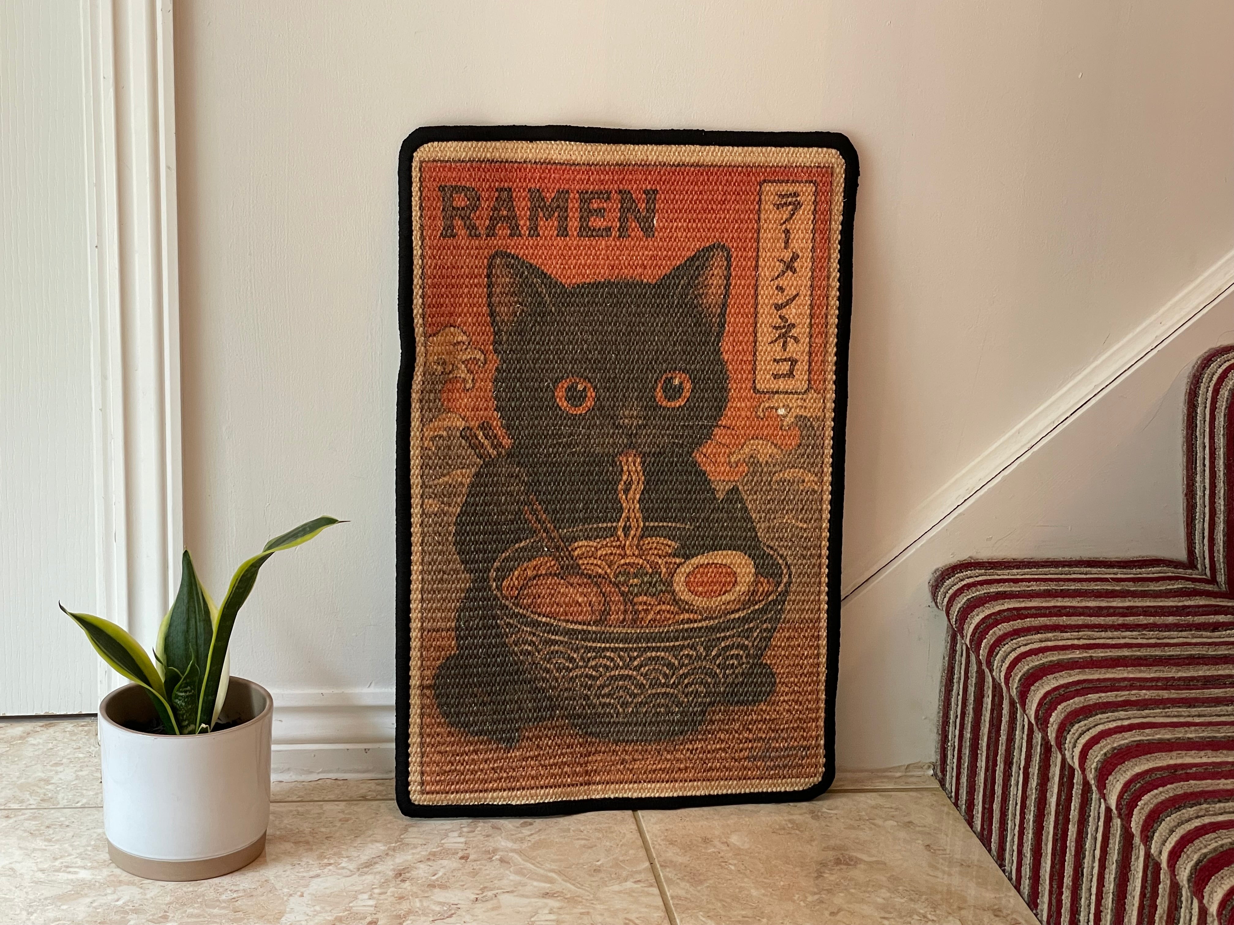 Cat scratching mat with slurping cat in ramen bowl design
