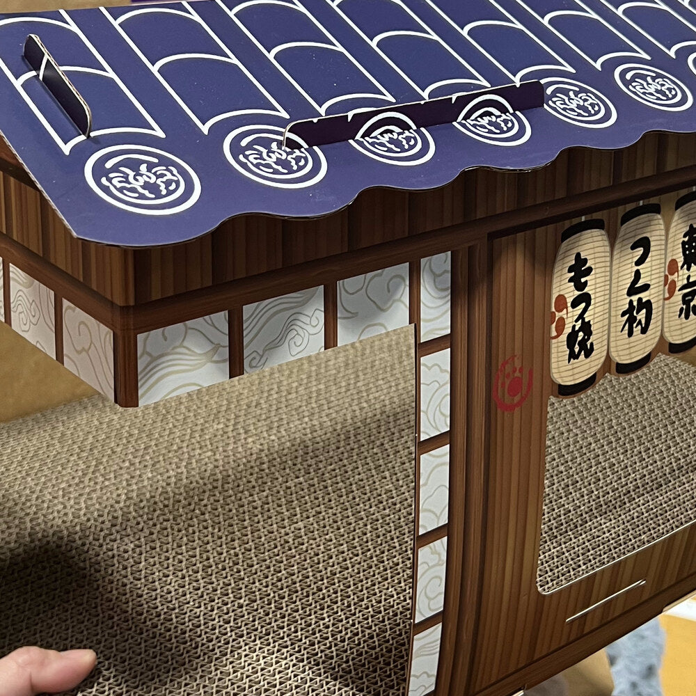 Inside view showing the corrugated cardboard scratch-pad floor and shoji-screen wallpaper
